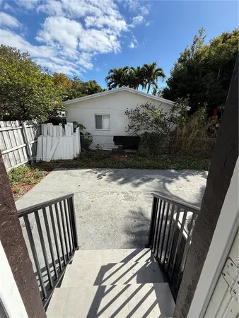 a view of a patio with two chairs and a table