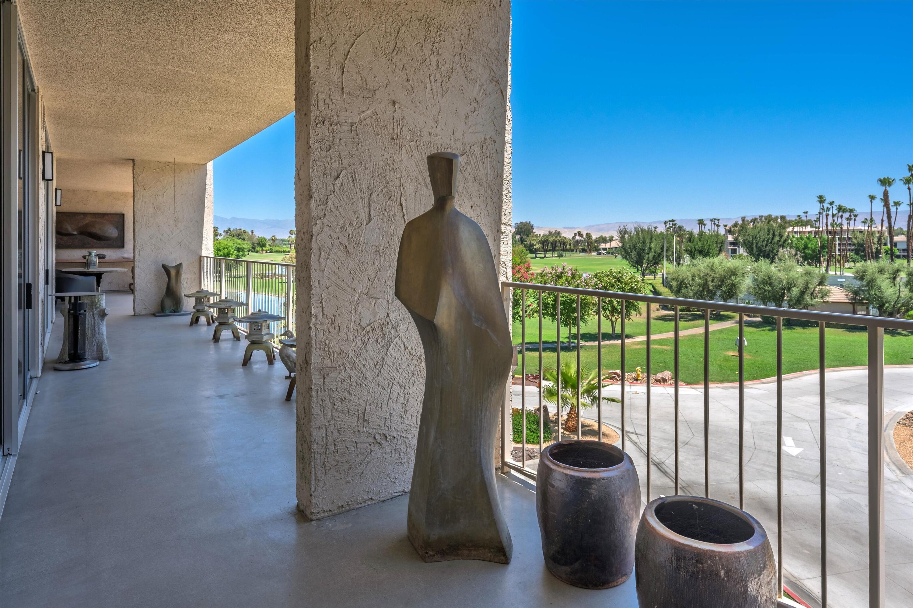899 Island Drive, Unit 304 Rancho Mirage, CA 92270 - Photo 21 of 30 a view of a porch with chairs and potted plants
