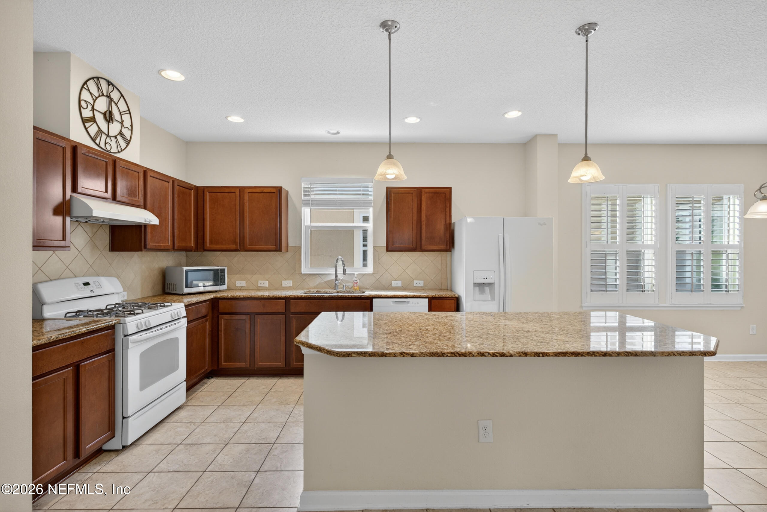 234 Taylor Ridge Avenue Ponte Vedra, FL 32081 - Photo 10 of 27 a kitchen with kitchen island granite countertop a stove a sink a oven a dining table and chairs