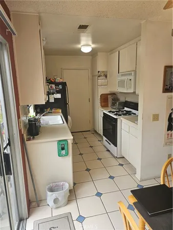 a kitchen with sink a stove and a refrigerator