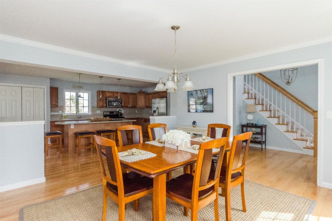 43 Converse Road Marion, MA 02738 - Photo 1 of 24 a dining room with furniture a kitchen and chandelier