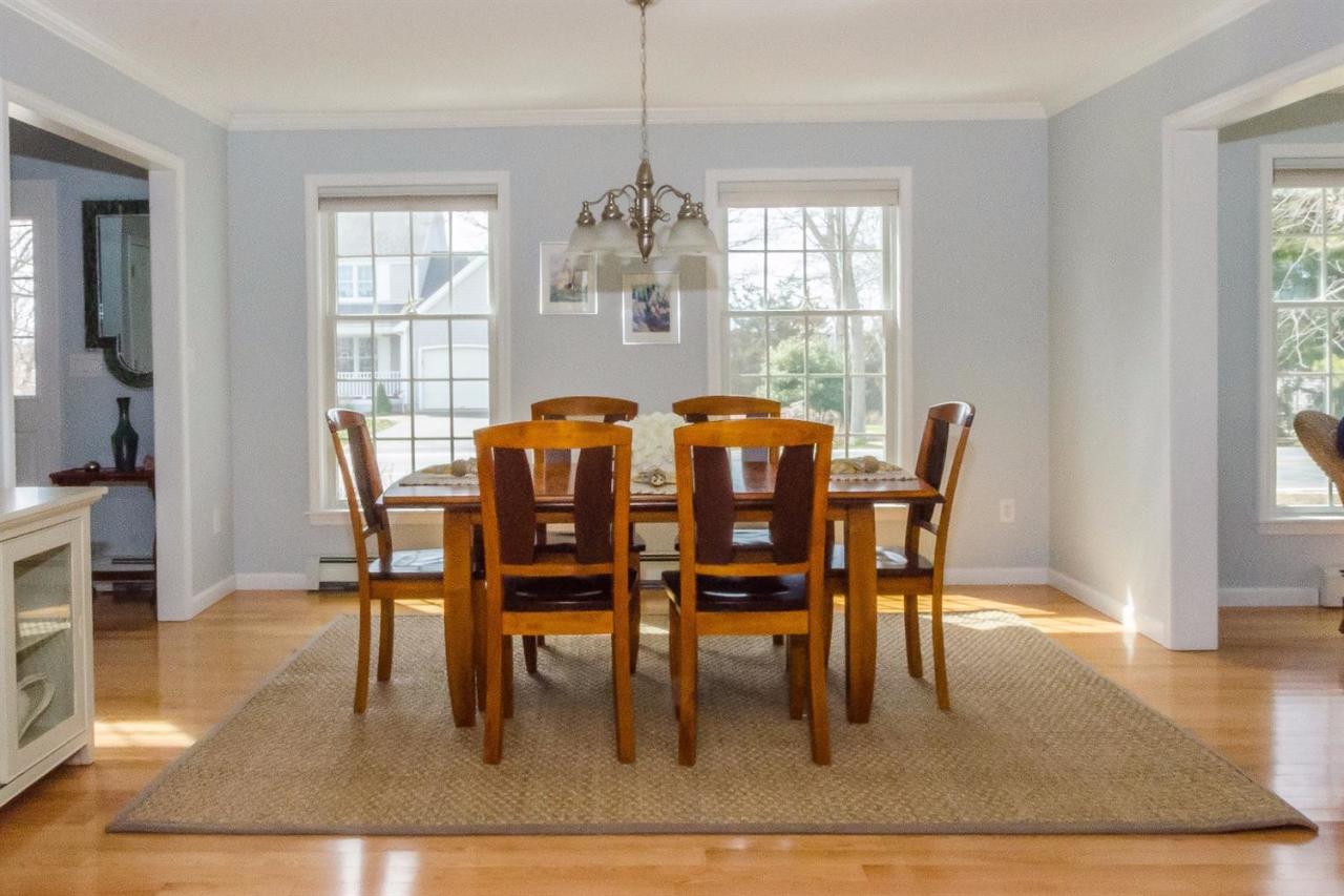 43 Converse Road Marion, MA 02738 - Photo 10 of 24 a dining room with furniture a chandelier and wooden floor
