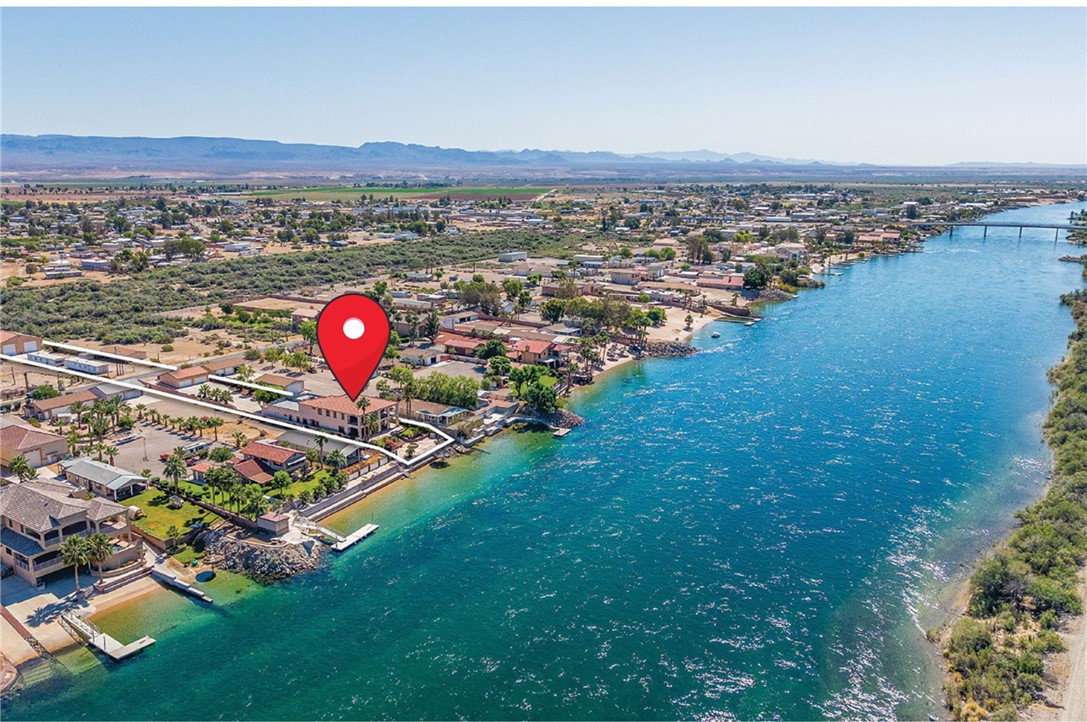 Waterfront property featuring direct river access, a private dock, and a sandy beach area