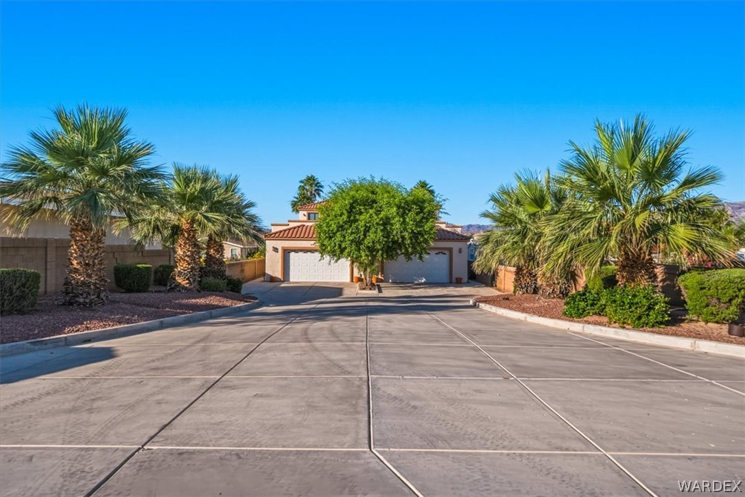 1084 Dike Road Mohave Valley, AZ 86440 - Photo 15 of 75 a view of a house with a yard and garage