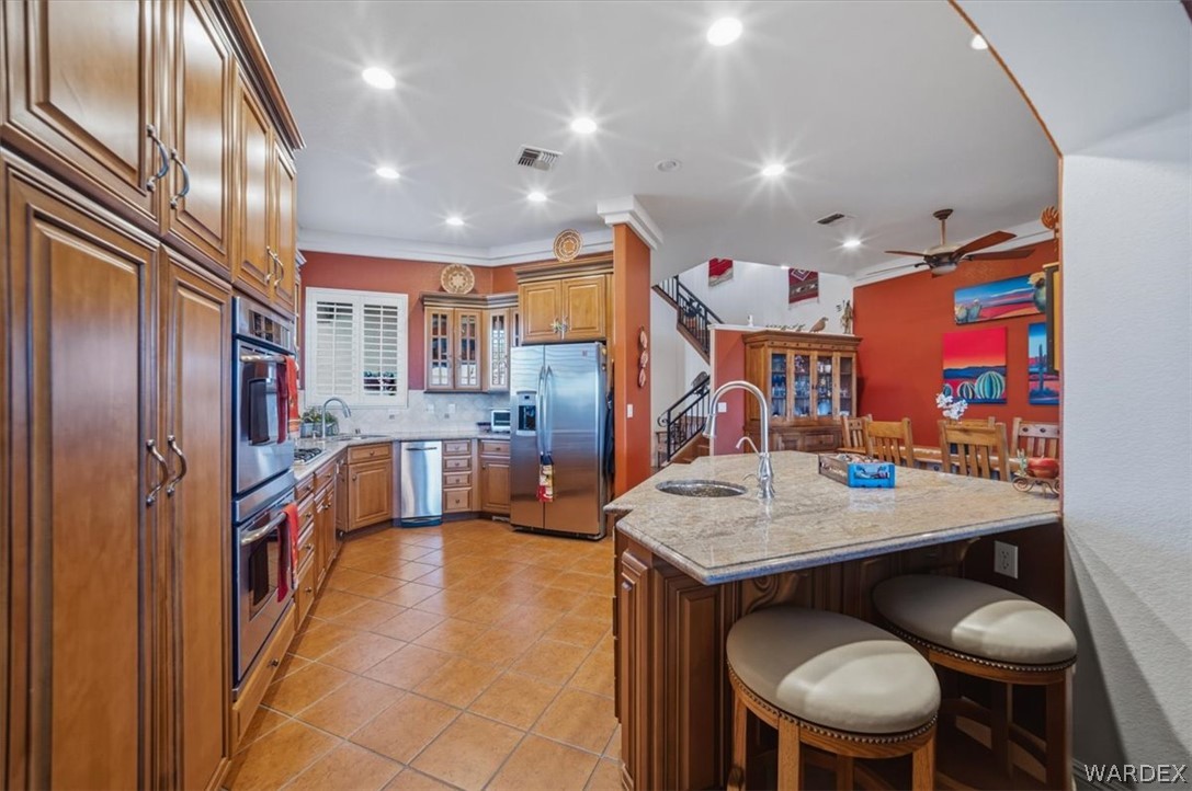 1084 Dike Road Mohave Valley, AZ 86440 - Photo 20 of 75 a kitchen with stainless steel appliances granite countertop a sink and a refrigerator