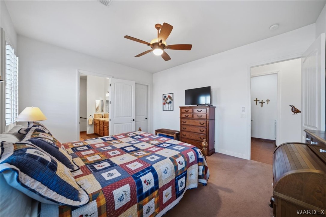 1084 Dike Road Mohave Valley, AZ 86440 - Photo 26 of 75 a bedroom with a bed and a chandelier