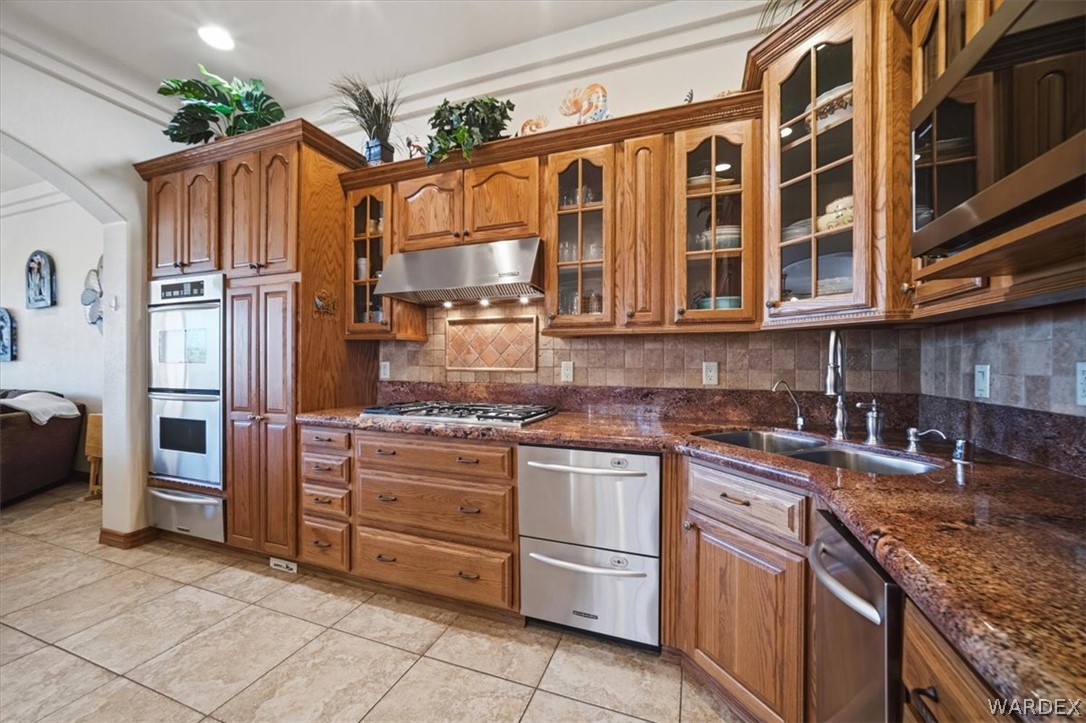 1084 Dike Road Mohave Valley, AZ 86440 - Photo 44 of 75 a kitchen with stainless steel appliances granite countertop a refrigerator and a stove top oven