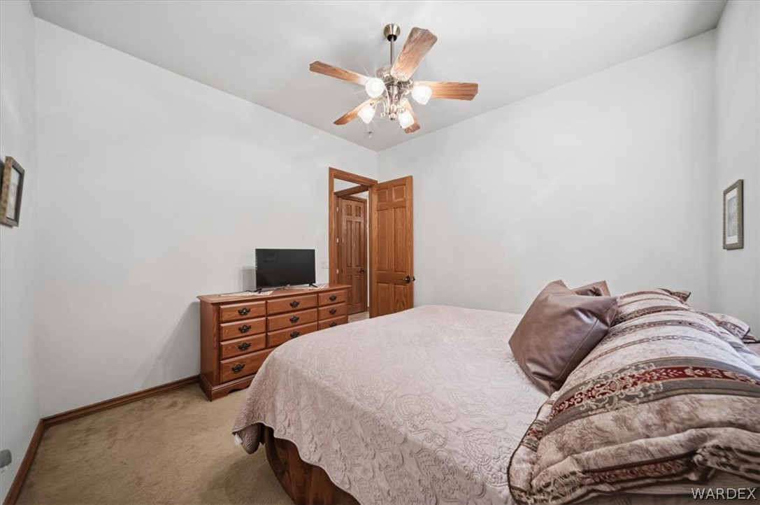 1084 Dike Road Mohave Valley, AZ 86440 - Photo 50 of 75 a bedroom with a bed and a chandelier