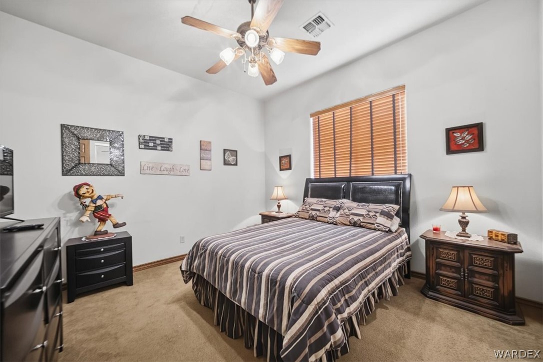 1084 Dike Road Mohave Valley, AZ 86440 - Photo 52 of 75 a bedroom with a bed and a chandelier