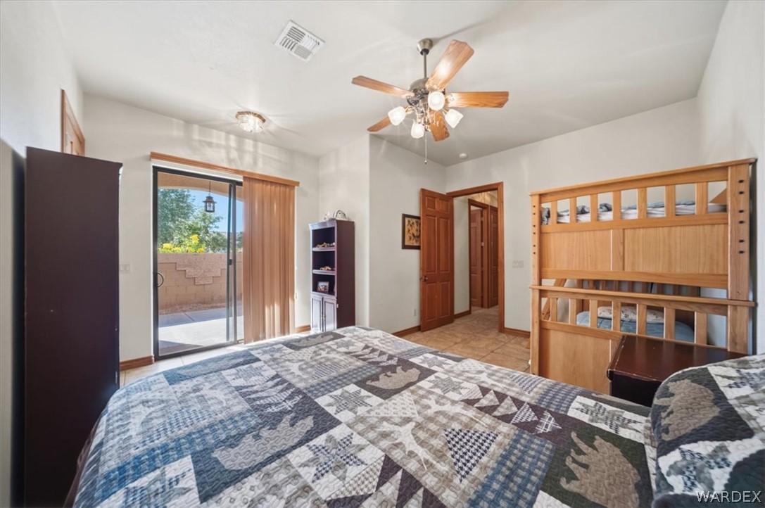 1084 Dike Road Mohave Valley, AZ 86440 - Photo 53 of 75 a bedroom with a bed dresser and a large window