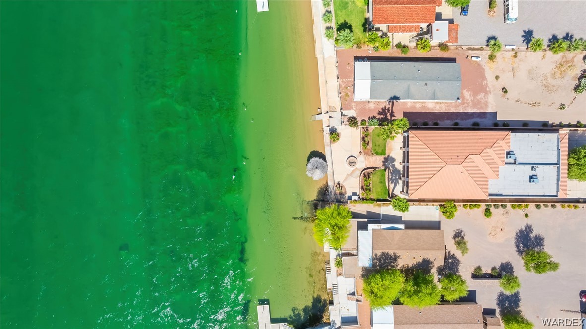 1084 Dike Road Mohave Valley, AZ 86440 - Photo 6 of 75 Waterfront property featuring direct beach access, and multiple buildings with tile roofs. Your private sandy beach and riverfront palapa create a true waterfront escape