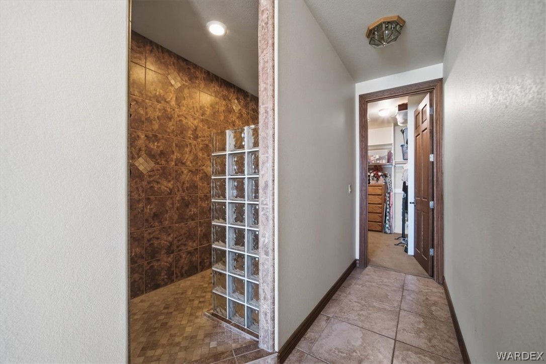 1084 Dike Road Mohave Valley, AZ 86440 - Photo 62 of 75 a view of a hallway with wooden floor and a bathroom
