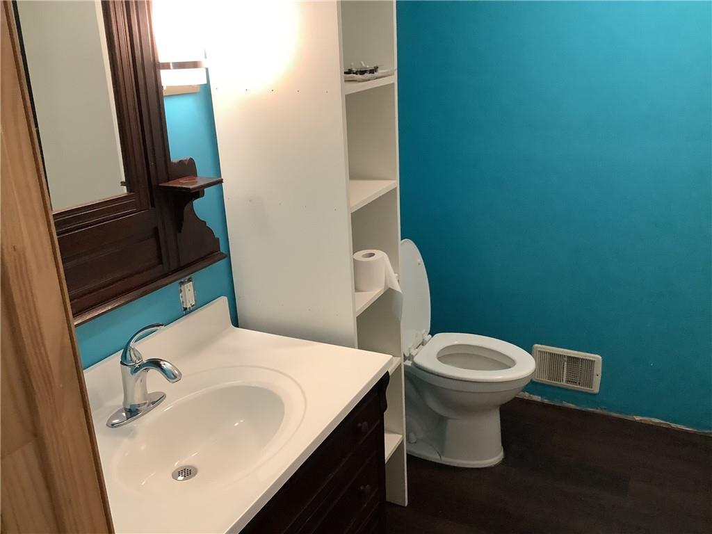 557 Hopper Road Transfer, PA 16154 - Photo 11 of 18 a white toilet sitting next to a bathroom sink