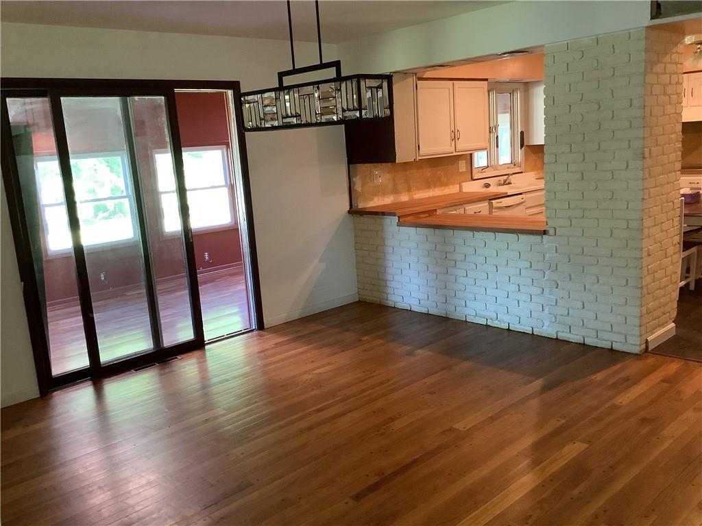 557 Hopper Road Transfer, PA 16154 - Photo 4 of 18 an empty room with wooden floor and windows