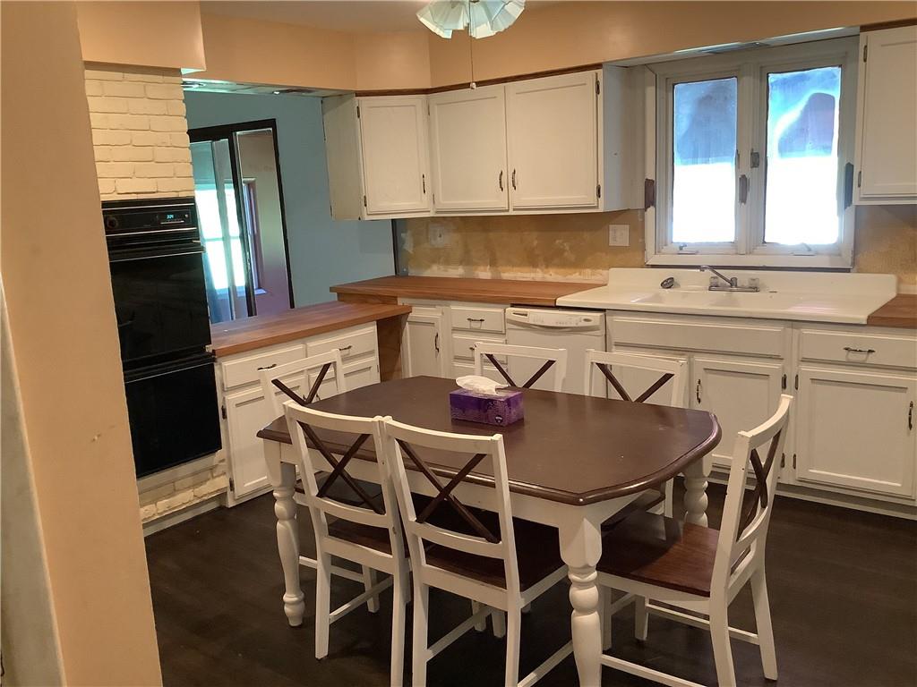 557 Hopper Road Transfer, PA 16154 - Photo 5 of 18 a kitchen with a table chairs a refrigerator and cabinets