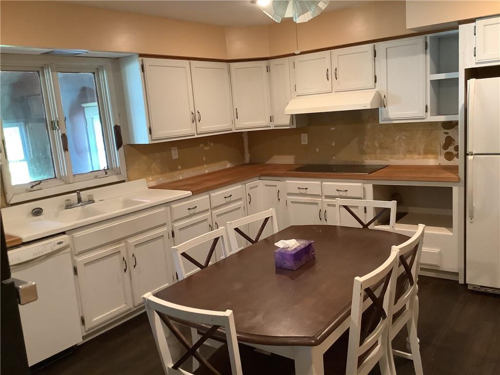 557 Hopper Road Transfer, PA 16154 - Photo 6 of 18 a kitchen with stainless steel appliances granite countertop a sink a stove a refrigerator a dining table and chairs
