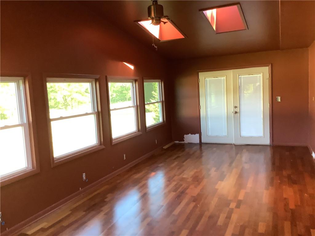 557 Hopper Road Transfer, PA 16154 - Photo 7 of 18 a view of an empty room with window and wooden floor