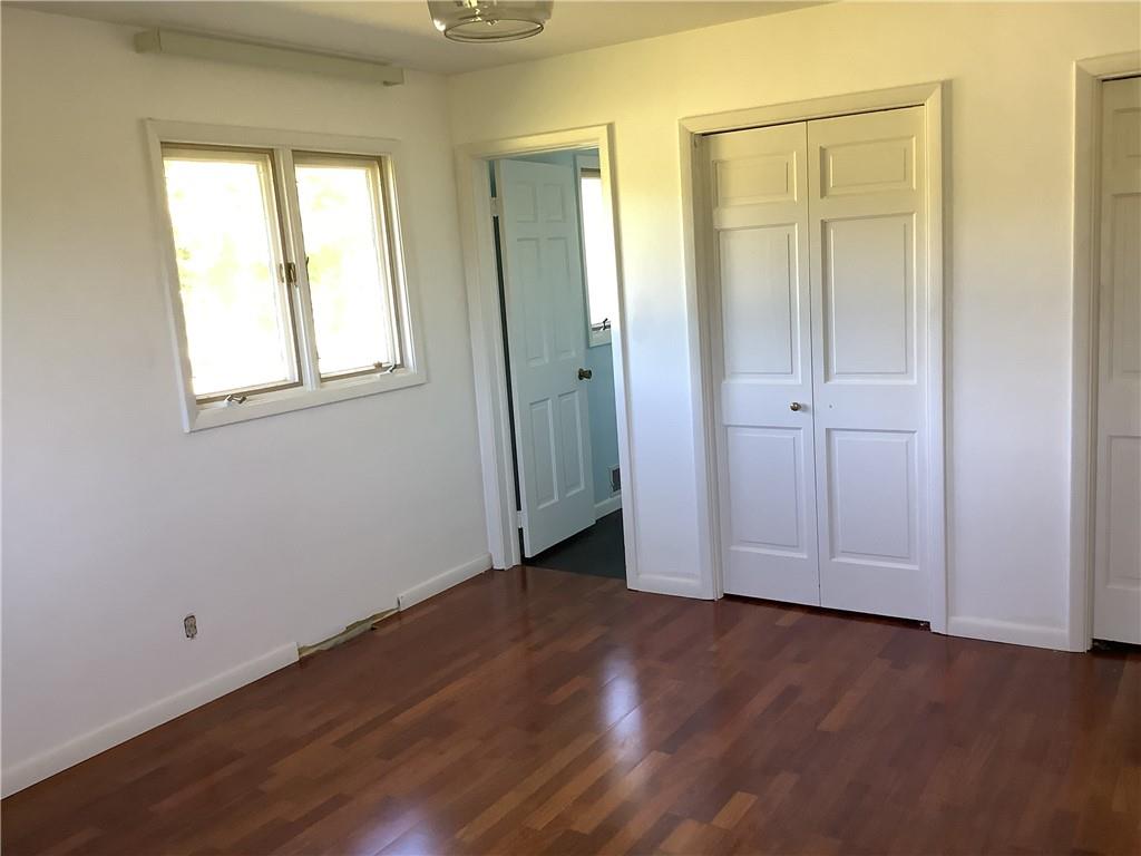 557 Hopper Road Transfer, PA 16154 - Photo 8 of 18 an empty room with wooden floor and closet area