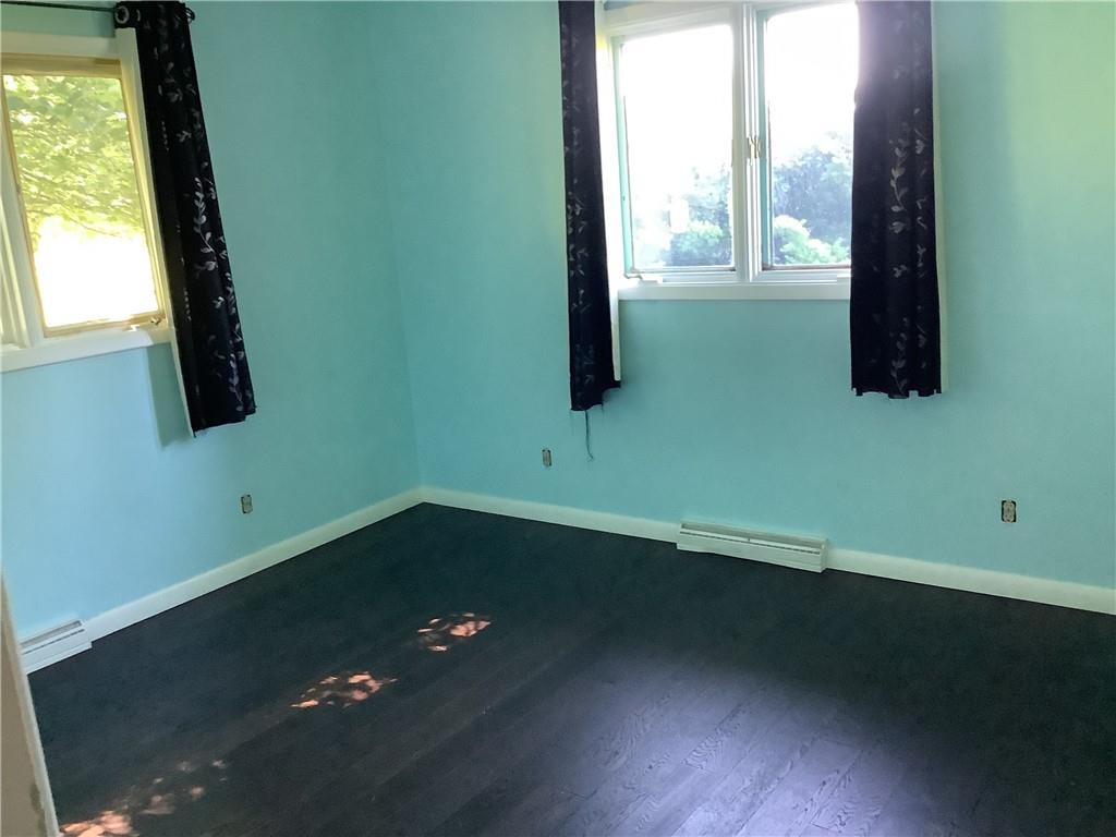 557 Hopper Road Transfer, PA 16154 - Photo 10 of 18 a view of an empty room with wooden floor and a window