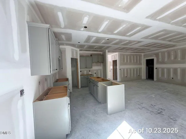 a large room with a large window and furniture