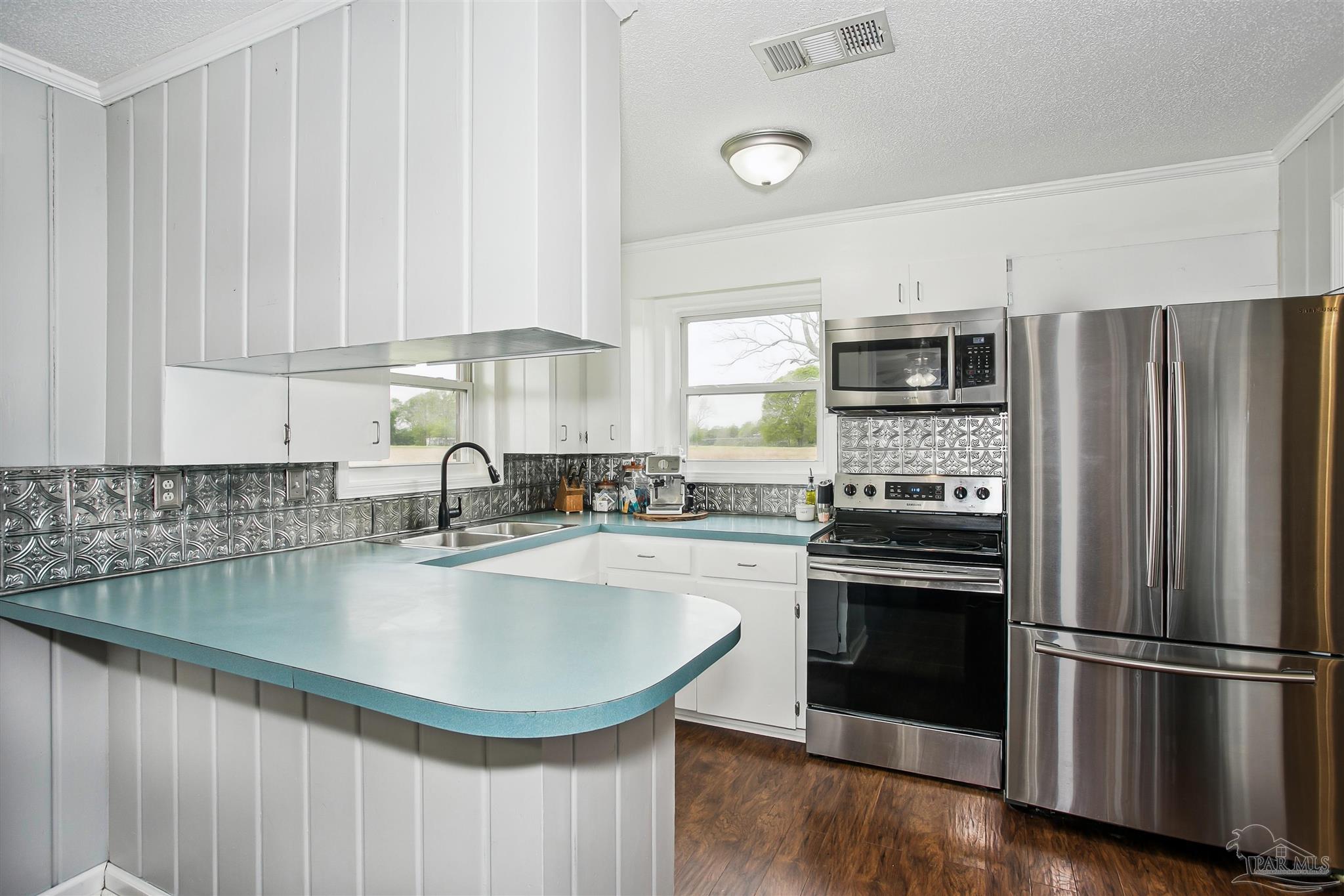 4075 Macks Road Century, FL 32535 - Photo 13 of 35 a kitchen with stainless steel appliances granite countertop a sink a stove a refrigerator and a granite counter tops