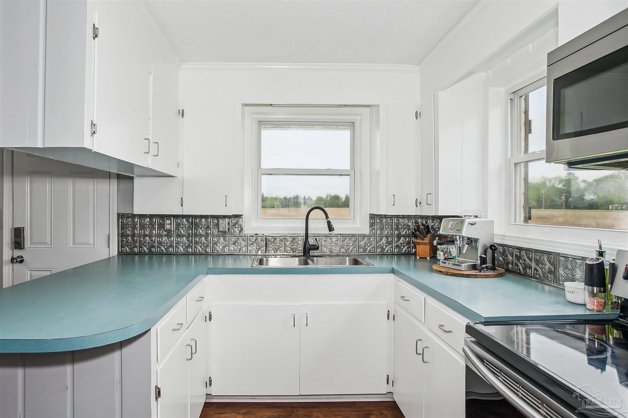 4075 Macks Road Century, FL 32535 - Photo 14 of 35 a kitchen with a sink cabinets and a window
