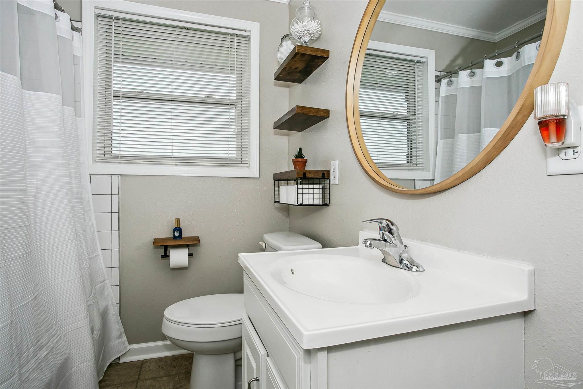 4075 Macks Road Century, FL 32535 - Photo 23 of 35 a bathroom with a sink toilet and a mirror