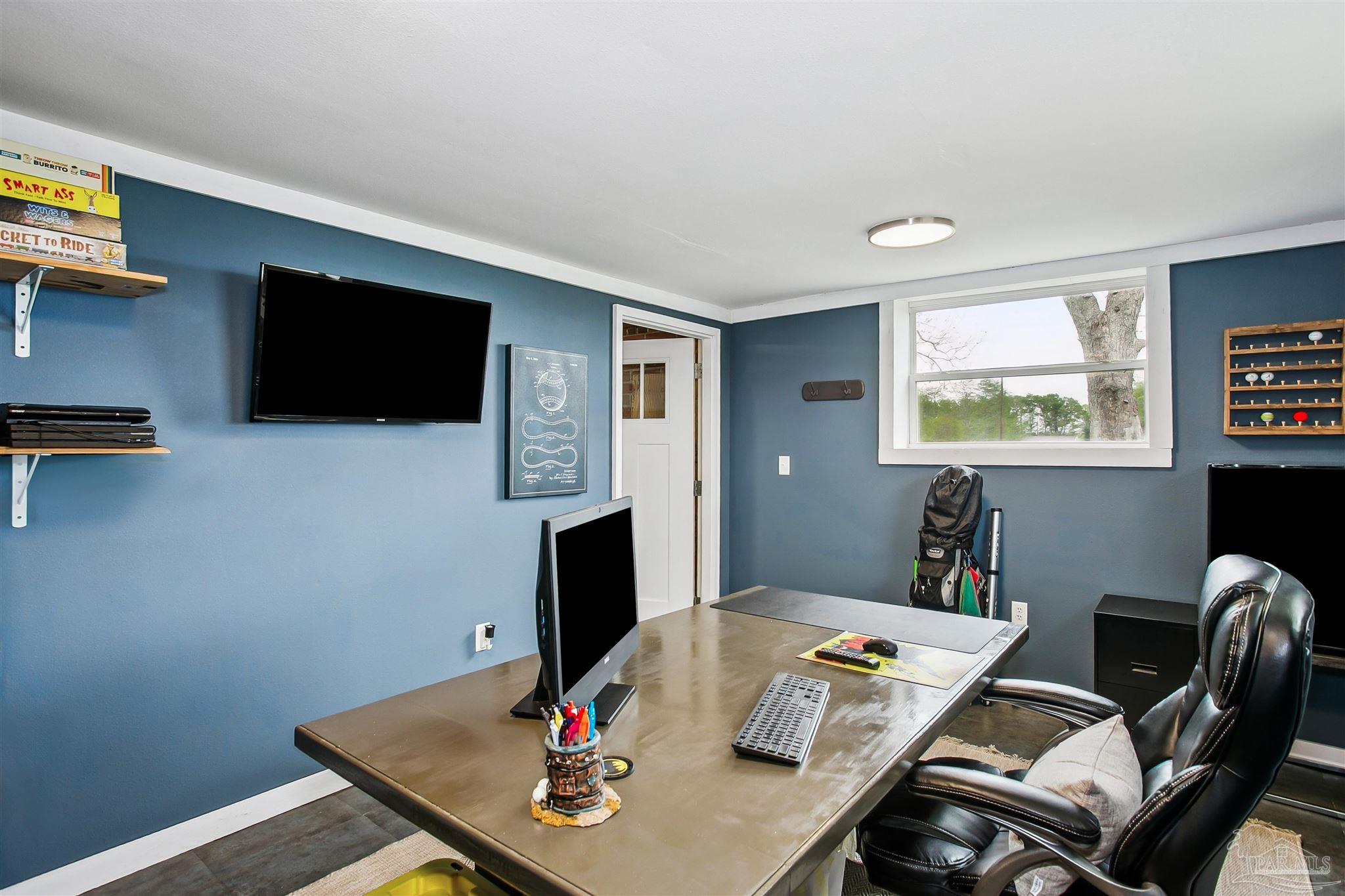 4075 Macks Road Century, FL 32535 - Photo 25 of 35 a living room with a flat screen tv and a window