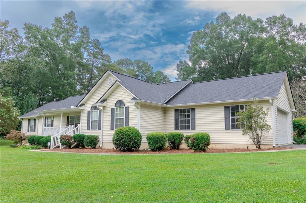 3171 Dews Pond Road Calhoun, GA 30701 - Photo 1 of 1 a front view of a house with a yard and garage