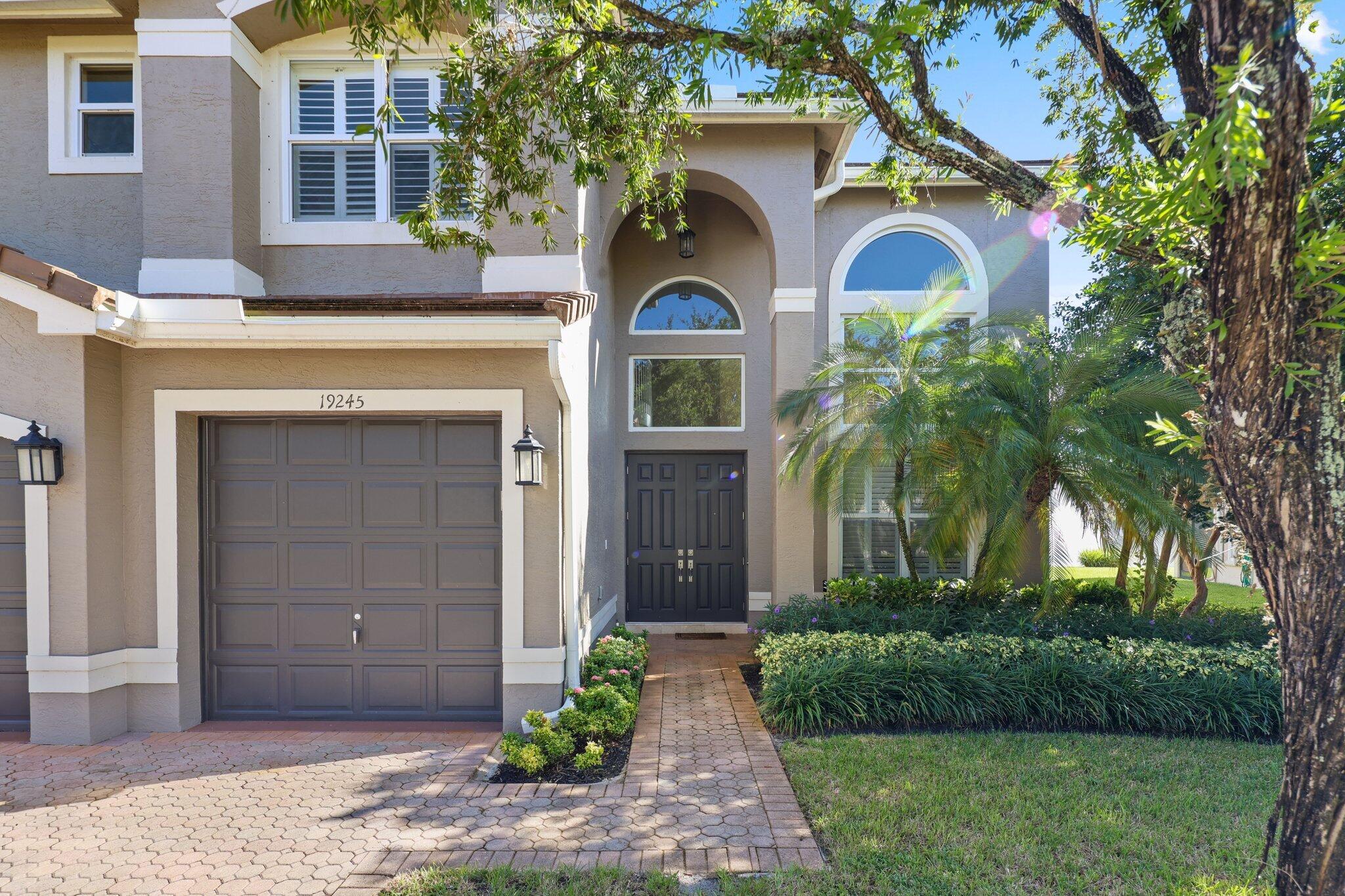 19245 Skyridge Circle Boca Raton, FL 33498 - Photo 5 of 70 a front view of a house with a garden