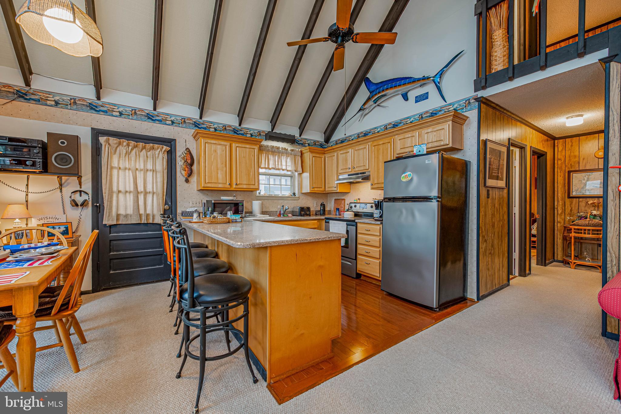 10602 Pine Needle Road Ocean City, MD 21842 - Photo 12 of 36 a view of a kitchen with furniture and a refrigerator