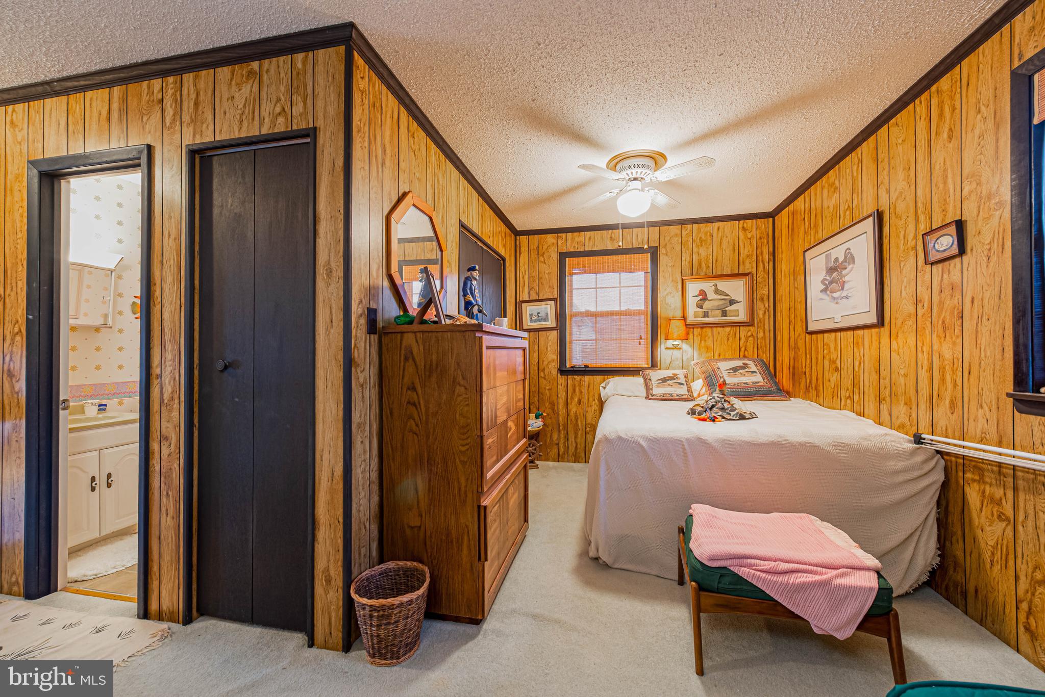 10602 Pine Needle Road Ocean City, MD 21842 - Photo 16 of 36 a bedroom with a bed and wooden floor