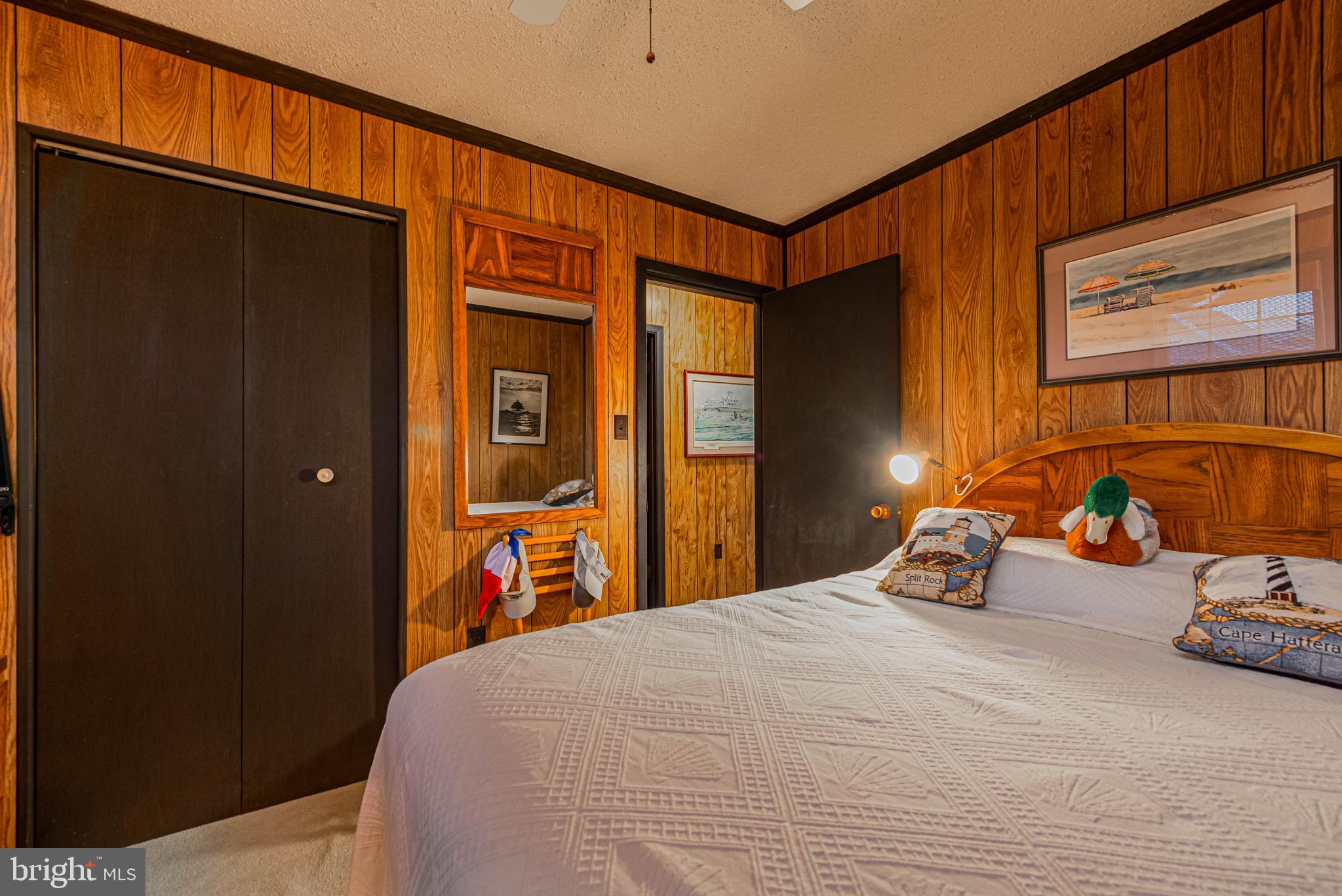 10602 Pine Needle Road Ocean City, MD 21842 - Photo 22 of 36 a bedroom with a bed and wooden floor