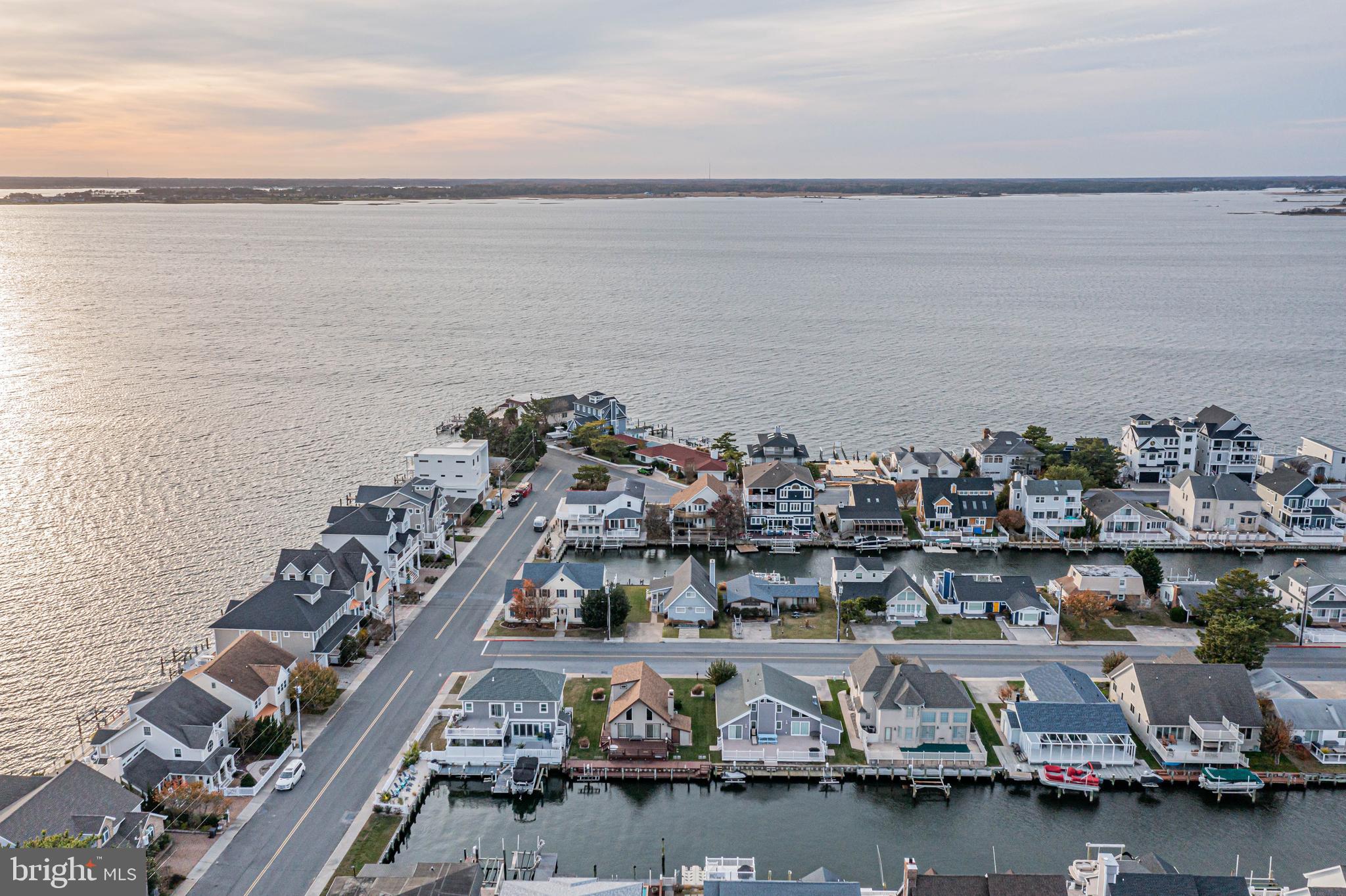 10602 Pine Needle Road Ocean City, MD 21842 - Photo 30 of 36 a view of a ocean with boats and trees in the background