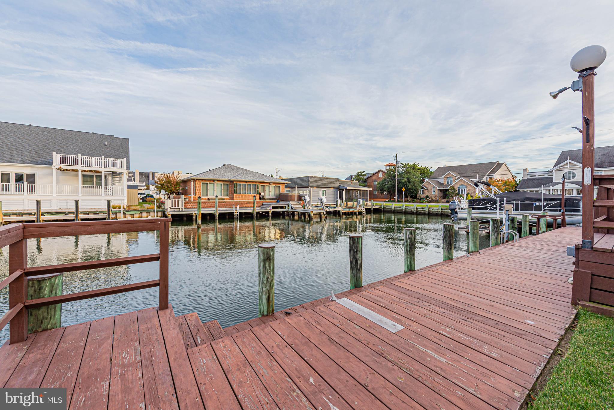 10602 Pine Needle Road Ocean City, MD 21842 - Photo 34 of 36 a balcony with wooden floor and lake view