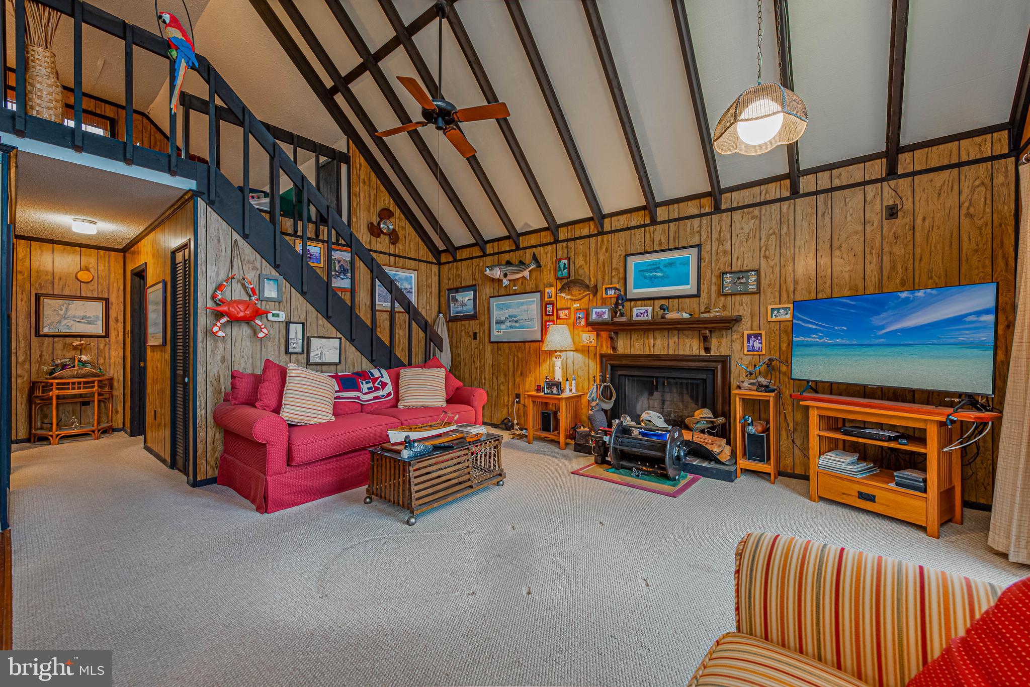 10602 Pine Needle Road Ocean City, MD 21842 - Photo 6 of 36 a view of a room with furniture wooden floor and a chandelier