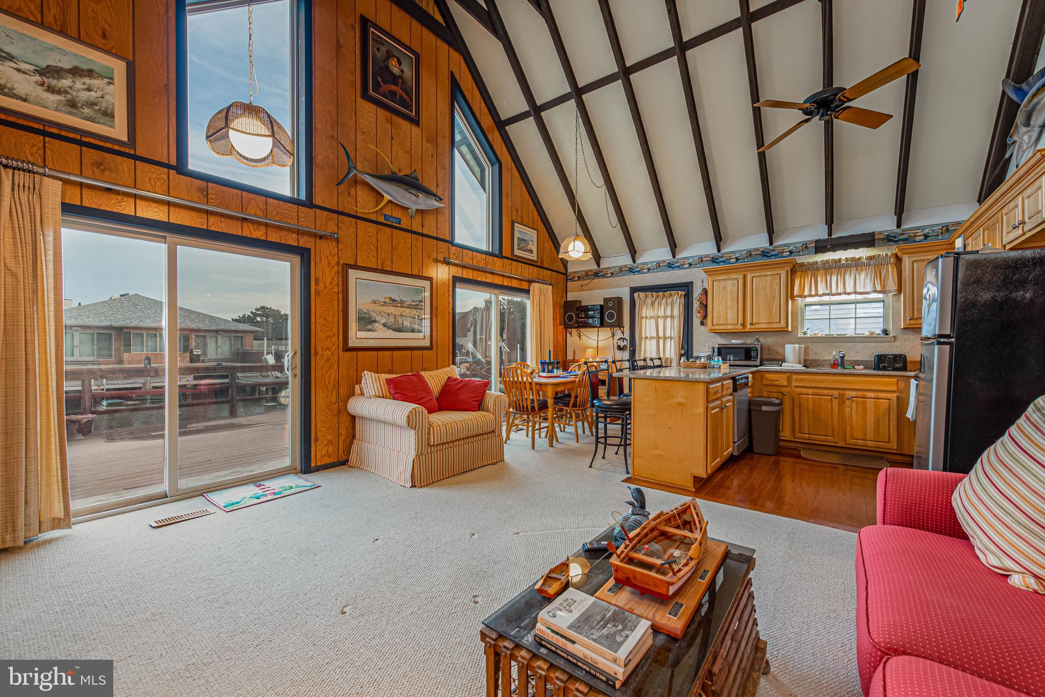 10602 Pine Needle Road Ocean City, MD 21842 - Photo 9 of 36 a living room with furniture a rug and a window