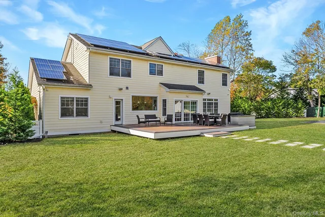a view of a house with swimming pool and a yard