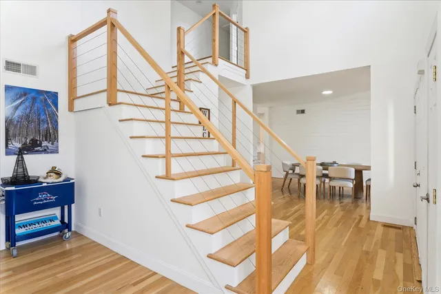 a view of entryway and hall with wooden floor