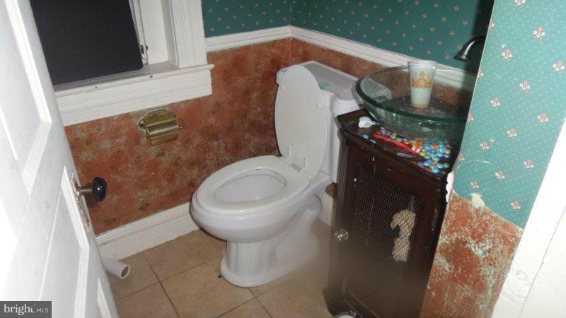 216 East Biddle Street Baltimore, MD 21202 - Photo 4 of 8 a bathroom with a toilet and a mirror