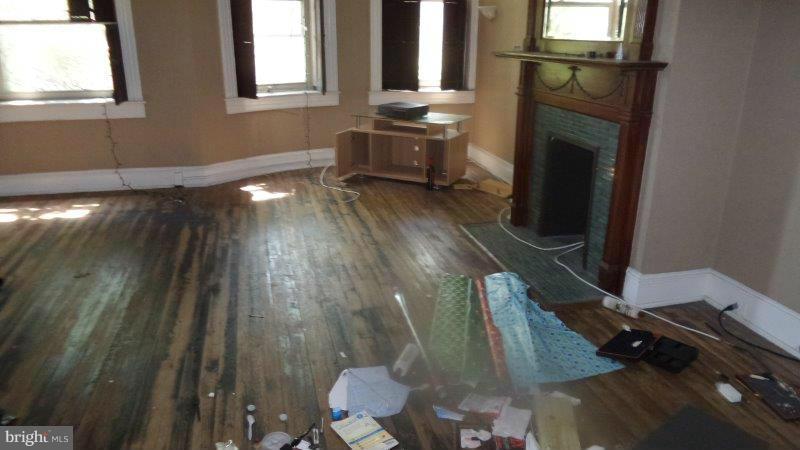 216 East Biddle Street Baltimore, MD 21202 - Photo 8 of 8 a living room with furniture and a fireplace