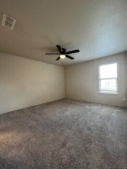 3205 112th Street Lubbock, TX 79423 - Photo 15 of 19 an empty room with a window and a ceiling fan