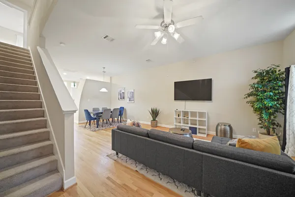 a living room with furniture and a potted plant