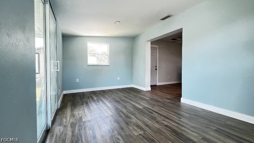 144 Whidden Road North Fort Myers, FL 33917 - Photo 14 of 16 an empty room with wooden floor and windows