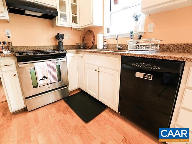 150 Olton Place Charlottesville, VA 22902 - Photo 17 of 40 a kitchen with granite countertop a stove sink and cabinets