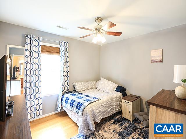 150 Olton Place Charlottesville, VA 22902 - Photo 20 of 40 a bedroom with a bed and a chandelier