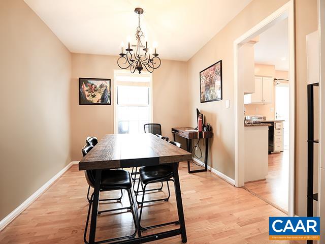 150 Olton Place Charlottesville, VA 22902 - Photo 6 of 40 a view of a dining room with furniture a chandelier and wooden floor