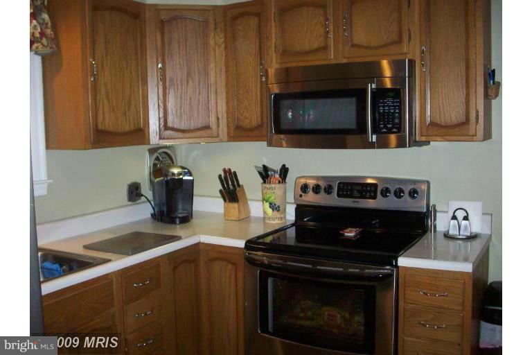 4313 Chapel Road Perry Hall, MD 21128 - Photo 7 of 23 a kitchen with stainless steel appliances granite countertop a stove and a microwave