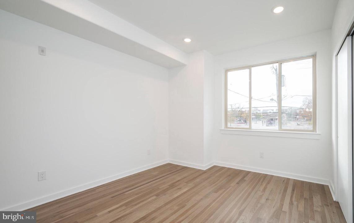 727 North 39th Street, Unit 2 Philadelphia, PA 19104 - Photo 11 of 15 an empty room with wooden floor and windows