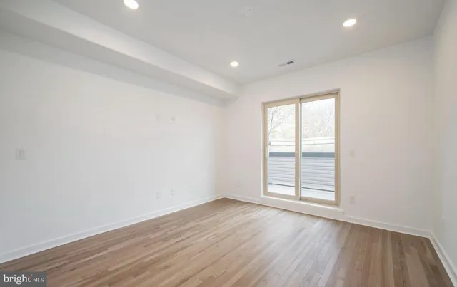 a view of a room with wooden floor